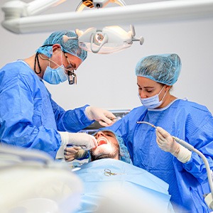 dental surgeon and assistant performing dental implant placement