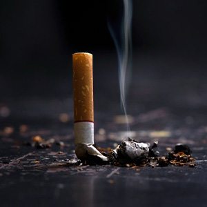 Extinguished cigarette still smolders