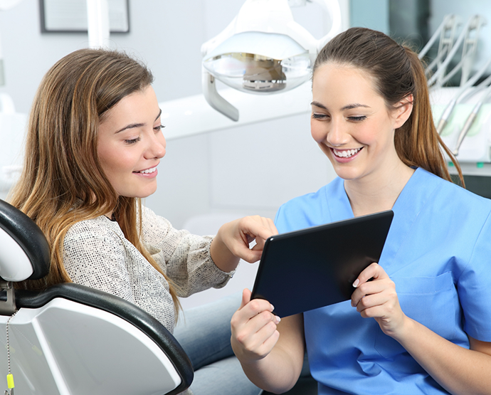 Dentist showing patient a tablet