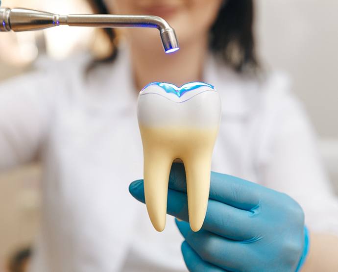Closeup of someone’s teeth reflected in dental mirror