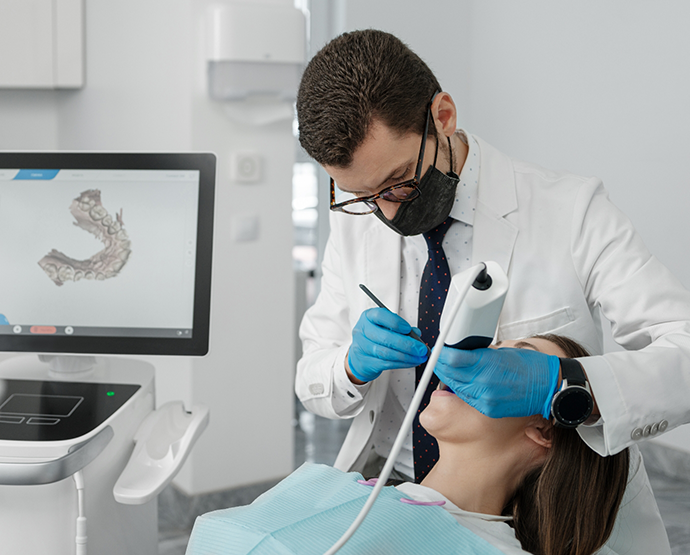 Dentist taking digital impressions of patients mouth