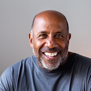 Closeup of man smiling in blue shirt