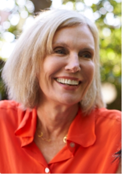 Senior woman in orange shirt smiling