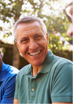Man in collared green shirt smiling