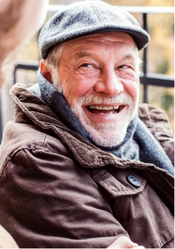 Senior man in cap grinning