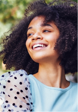 Close up of woman standing outside and smiling