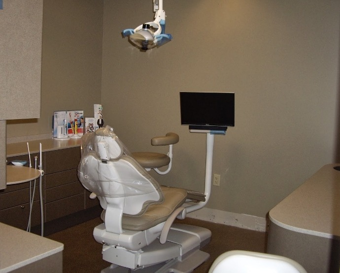 Empty dental chair next to monitor