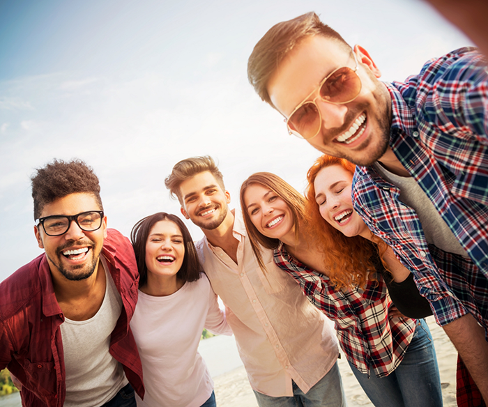 Many people standing in a row and smiling