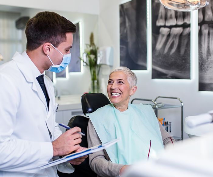 Woman looking up and smiling at dentist