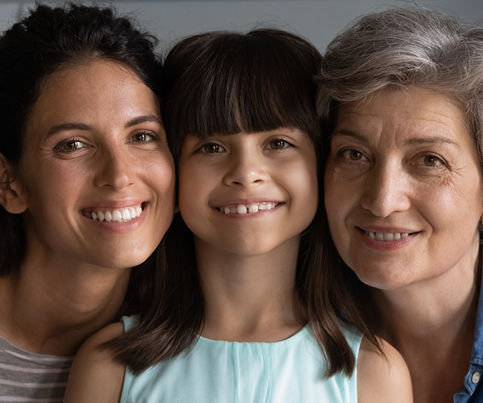 Little girl and two women smiling
