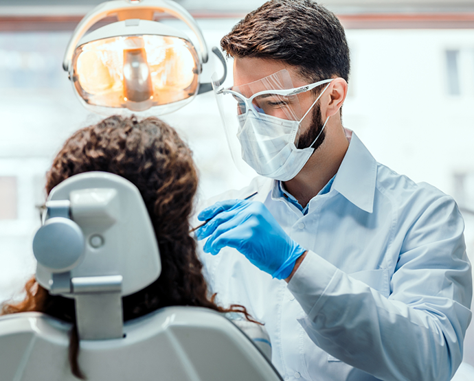 Dentist examining patients teeth