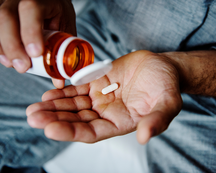 Close up of pill in palm of hand