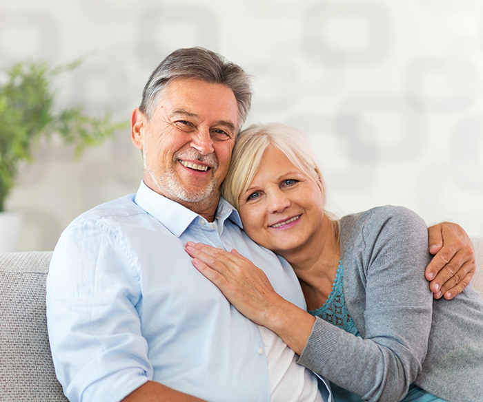 Man and woman hugging each other on couch