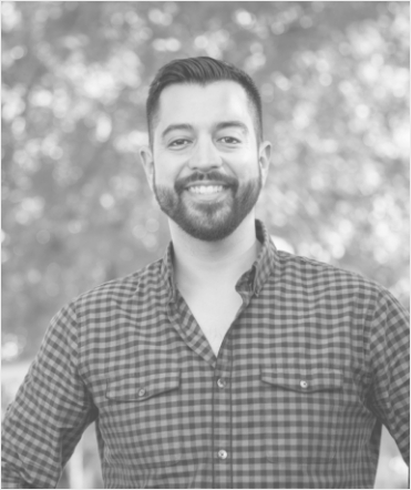 Man in patterned shirt smiling