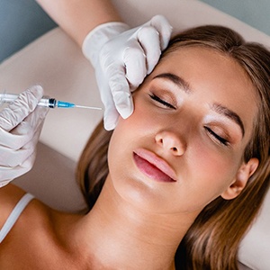 Woman receiving injection near her jaw