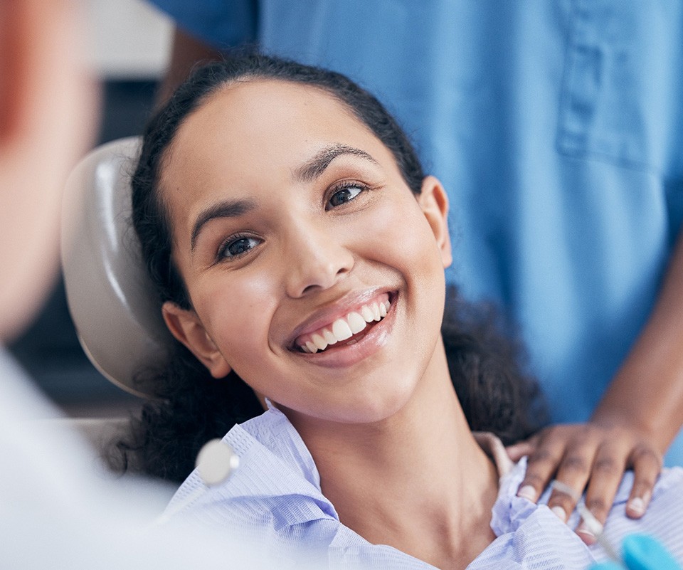 Teeth whitening patient in St. Augustine smiling at dentist