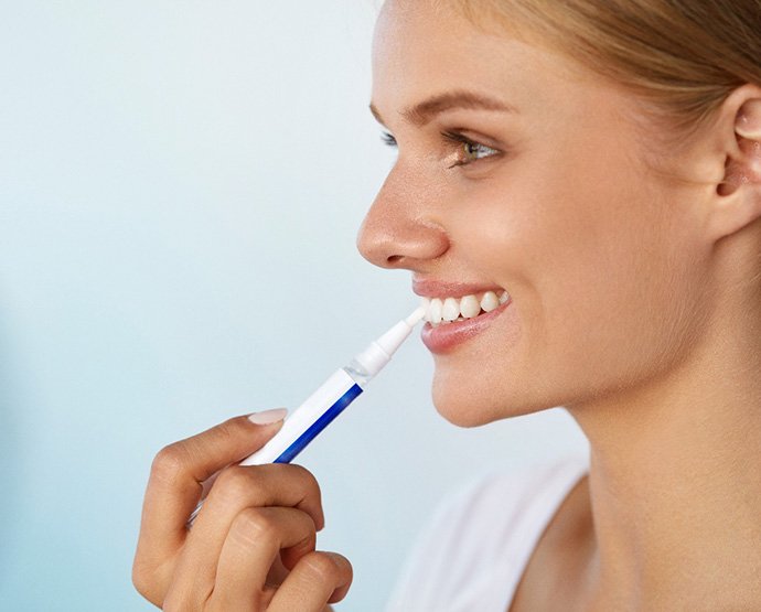 Teeth whitening patient in St. Augustine using whitening pen