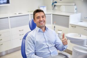 Man smiling and giving thumbs up